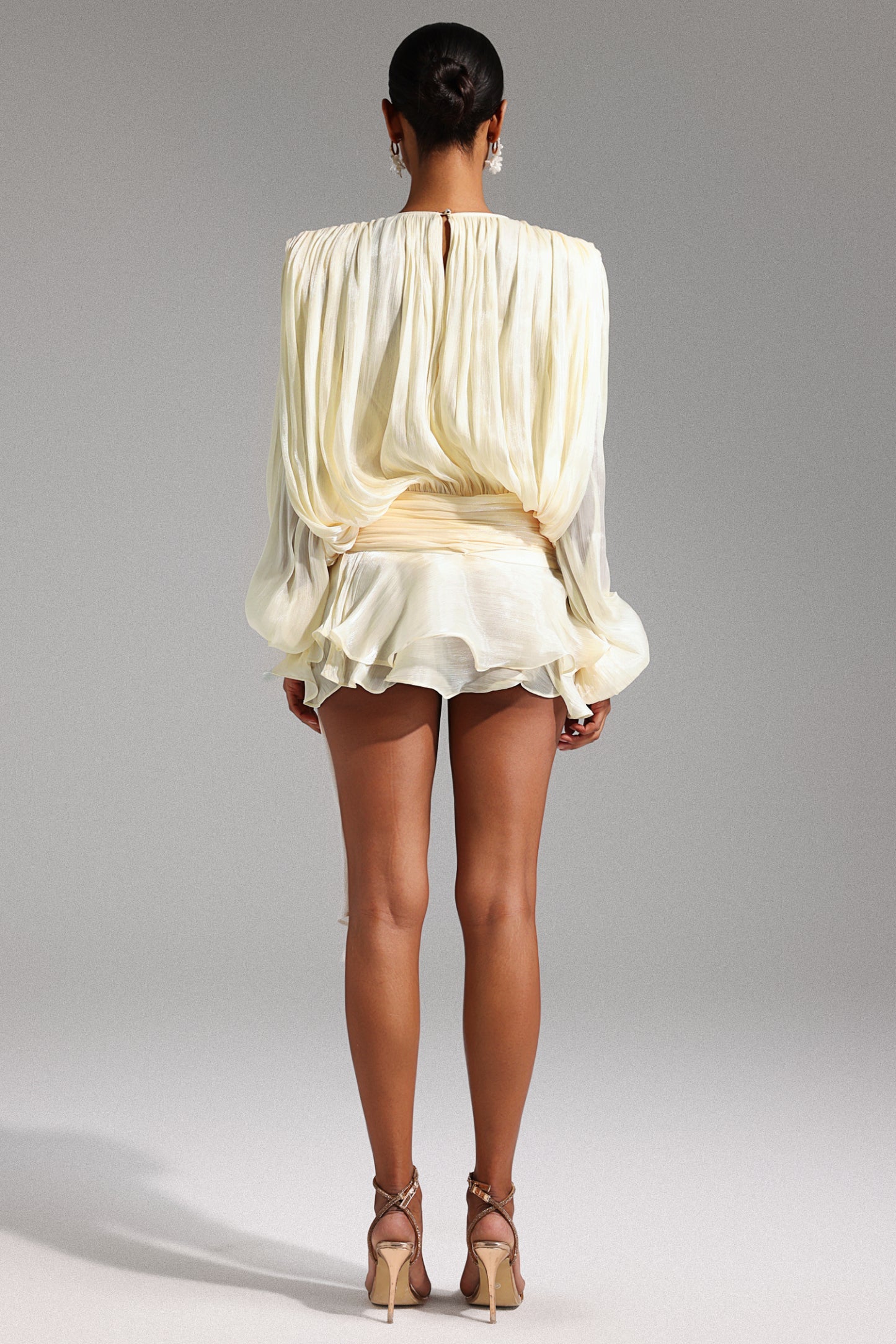 Women wearing short white dress, with 3D design on a gray background