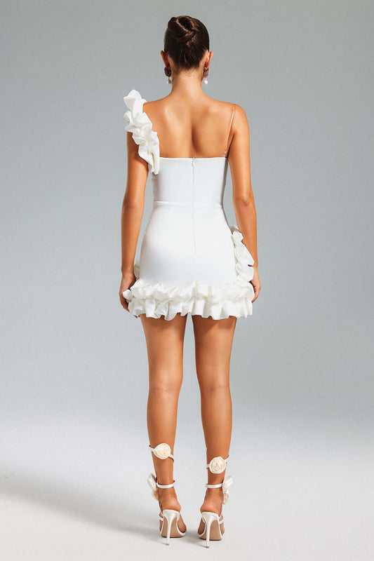 Women wearing short white dress, with 3D floral design on a gray background
