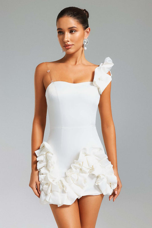 Women wearing short white dress, with 3D floral design on a gray background